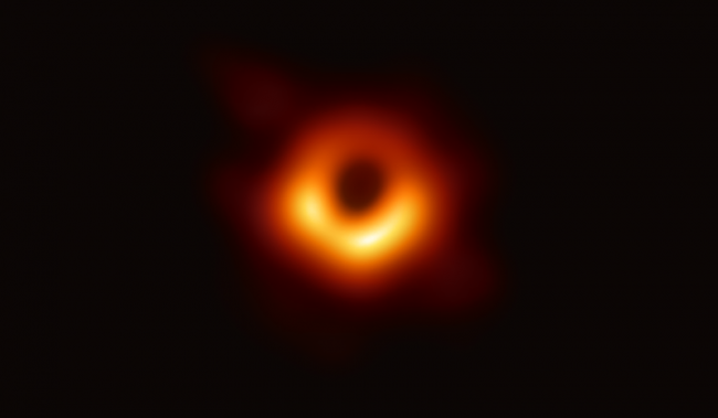 black background with orange circle around a black center