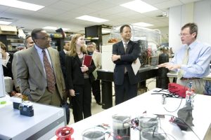 People in suits in a lab