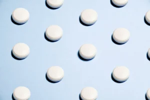 White round capsules on a blue background